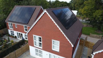 Aerial view of all-black solar panels installed on two neighbouring homes